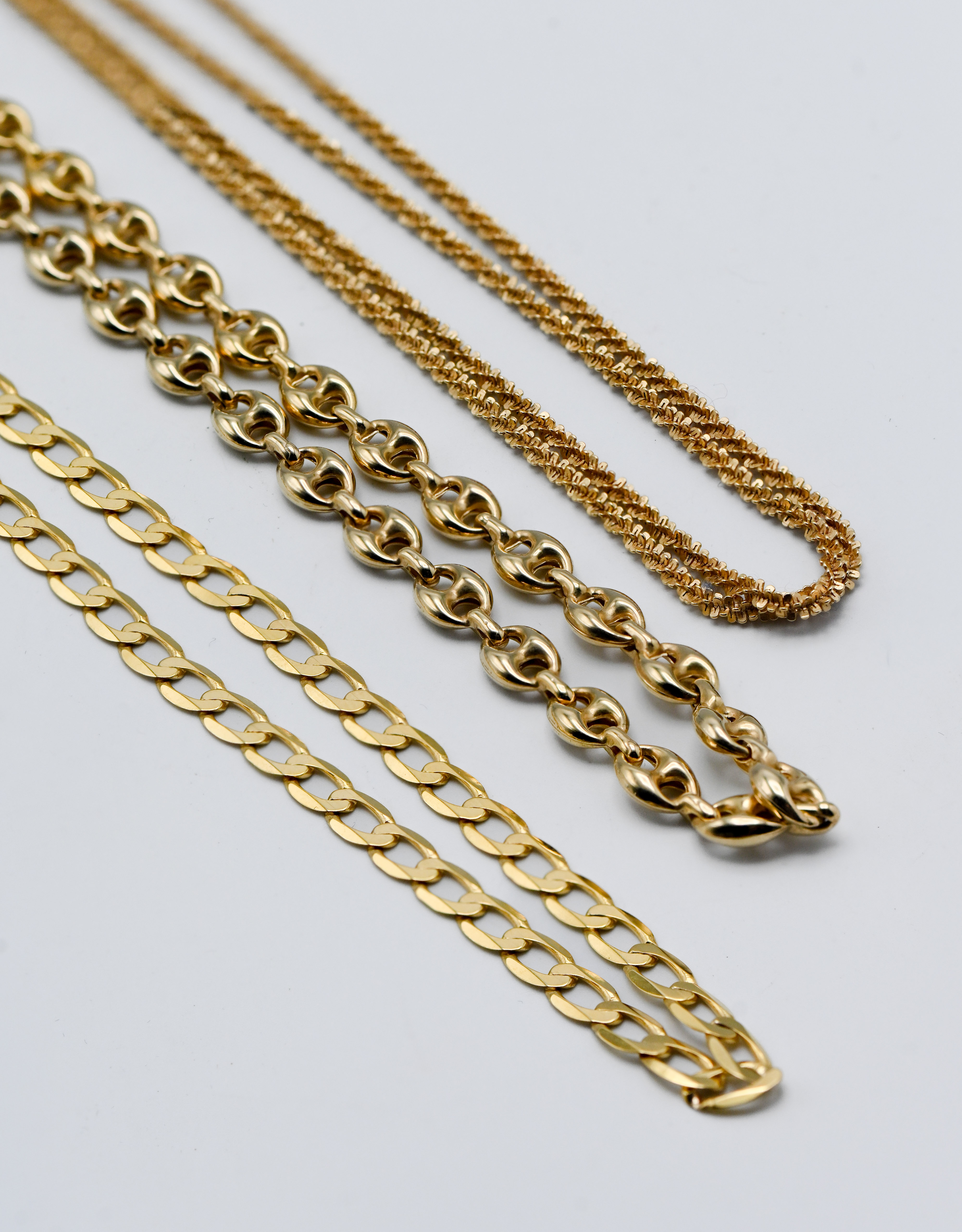 Three 9ct gold necklaces, approx. 25.35g (one chain broken)