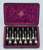 An Elkington & Co. 12 piece silver apostle cake fork set. Victorian, London. Makers mark FE, in