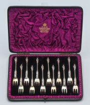 An Elkington & Co. 12 piece silver apostle cake fork set. Victorian, London. Makers mark FE, in