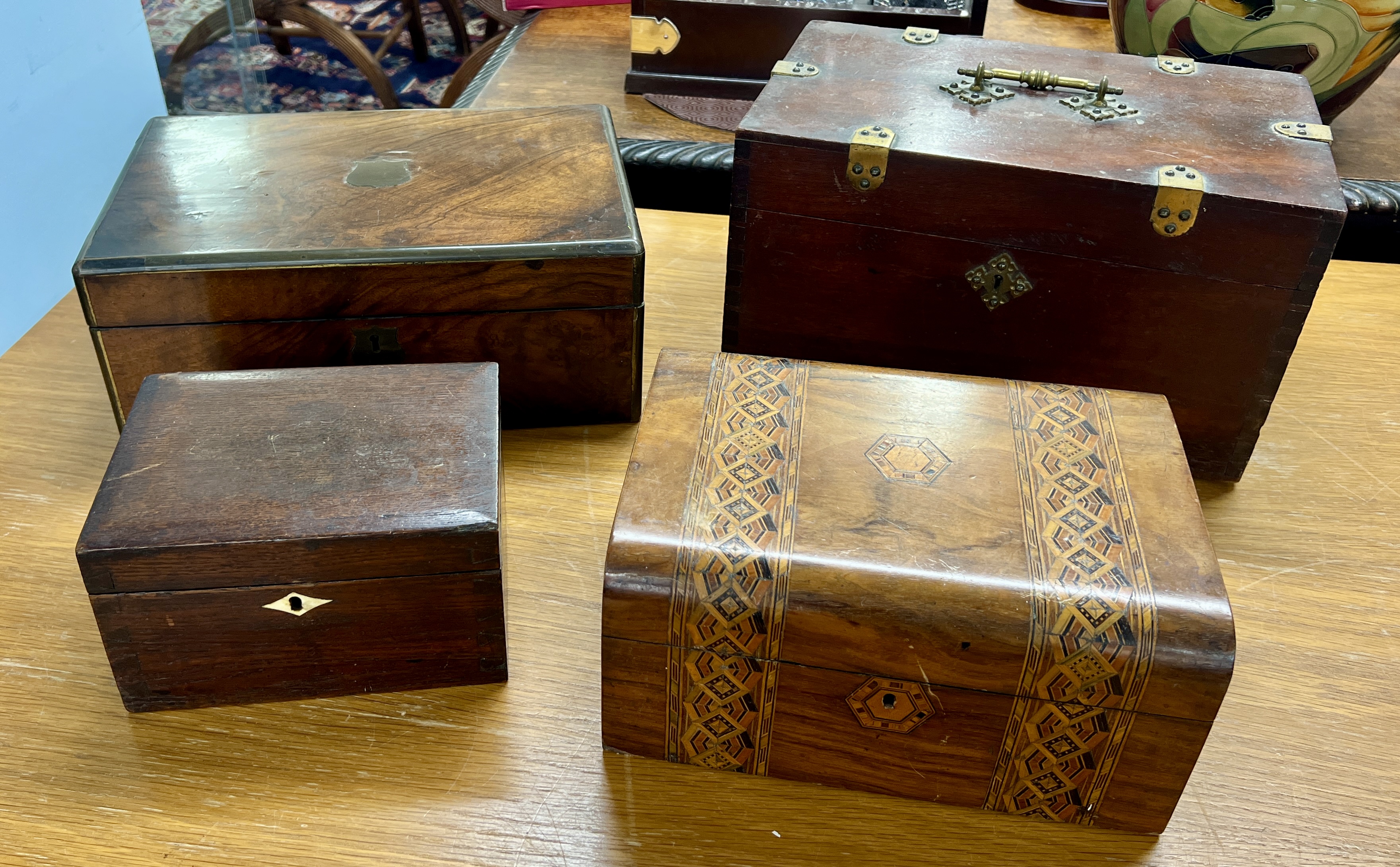 A collection of four boxes including a writing box.