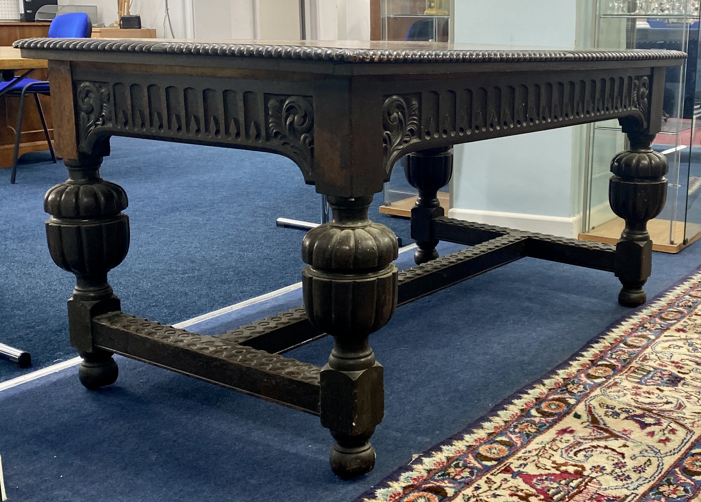 A Jacobean style carved oak dining table, height 75cm, width 143cm.