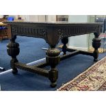A Jacobean style carved oak dining table, height 75cm, width 143cm.