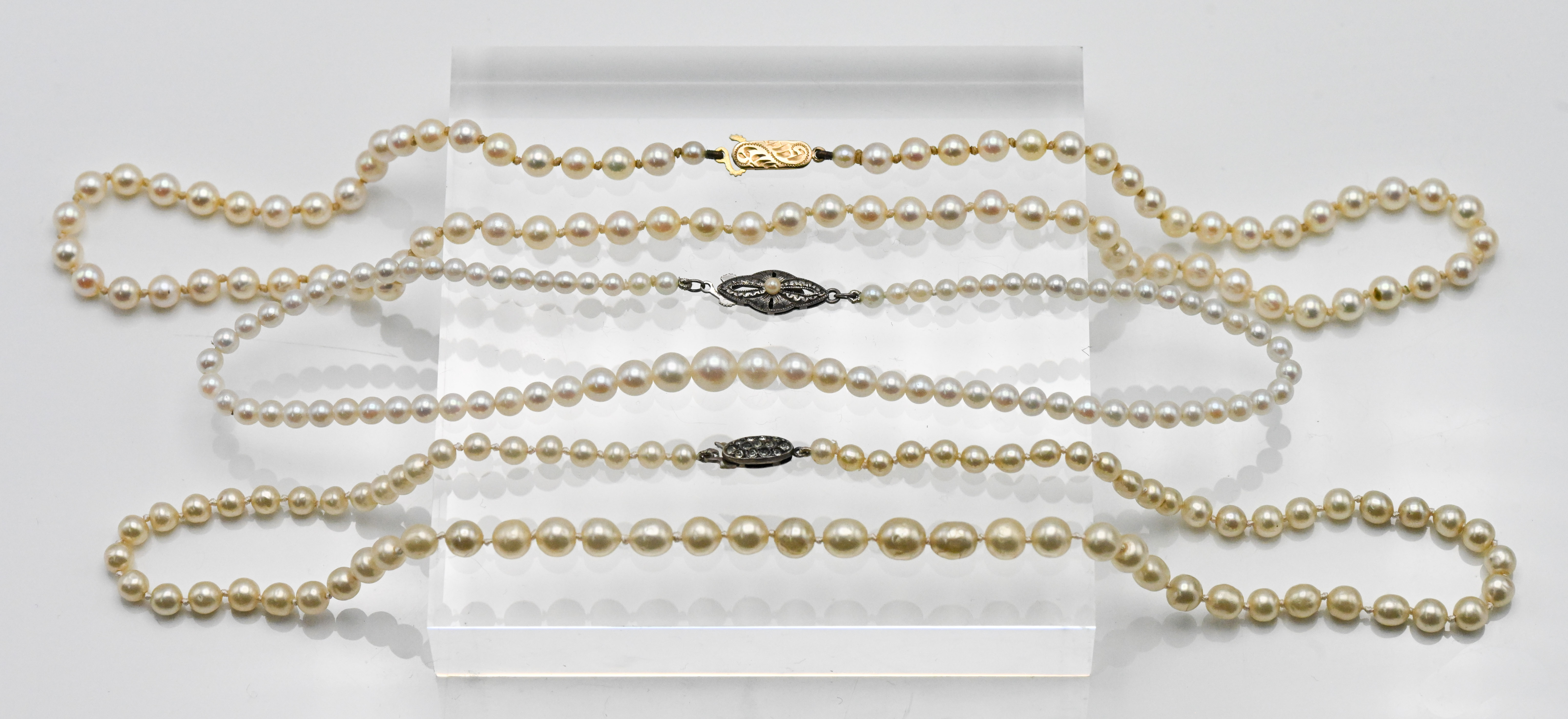 Three Cultured pearl necklaces to include single row with silver clasp, approx. length: 16cm, single