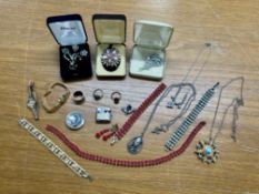 A mixed collection of costume jewellery including brooches, necklaces etc.