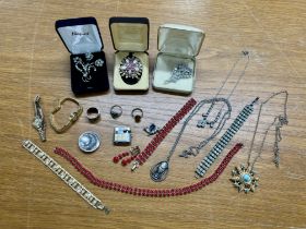A mixed collection of costume jewellery including brooches, necklaces etc.