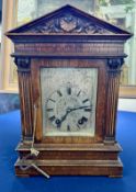 A Victorian architectural wood cased mantel clock. The dial inscribed Goldsmiths Company London.