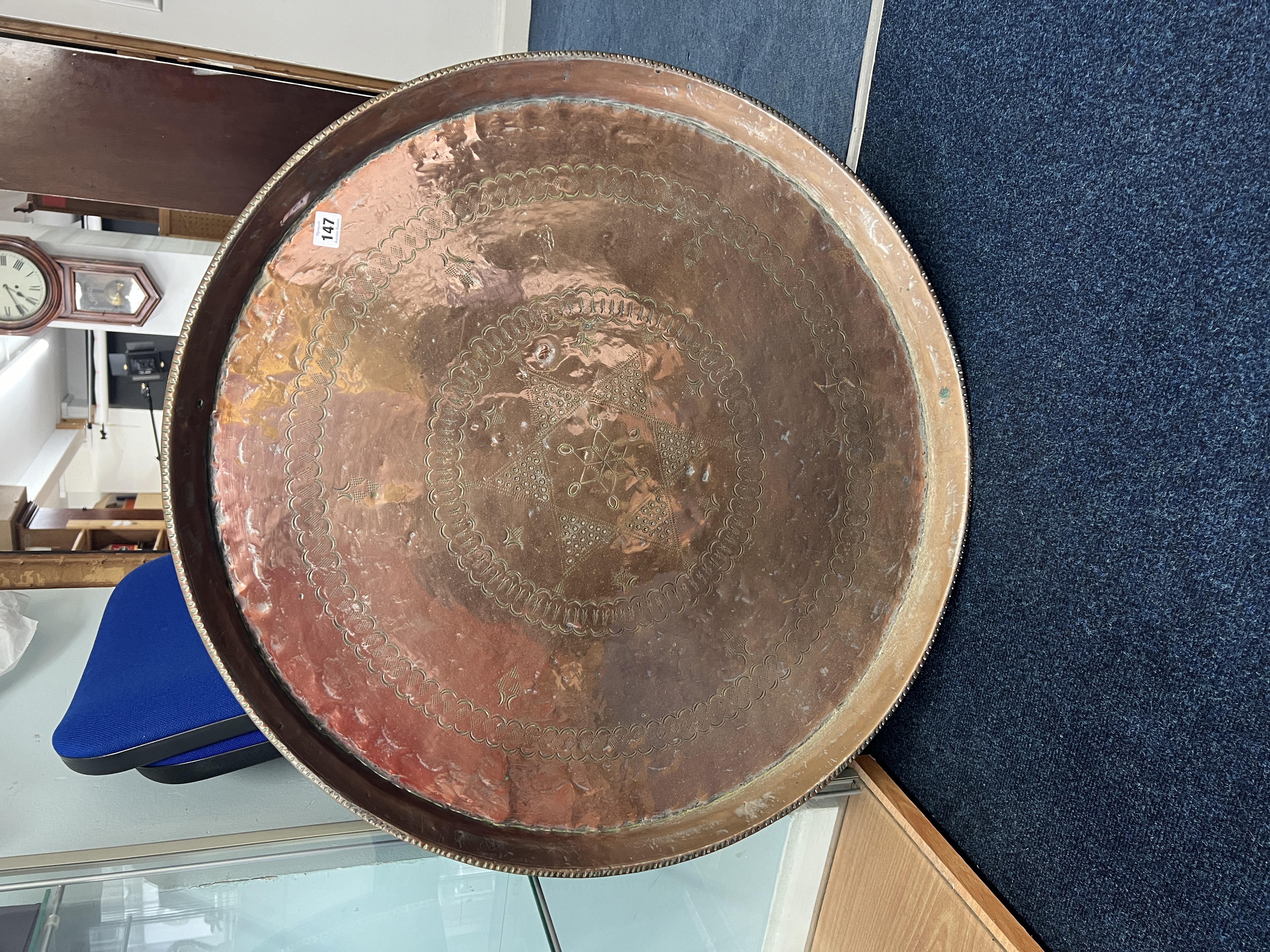 A large early 20th century circular copper tray, 78cm diameter