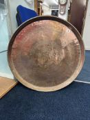 A large early 20th century circular copper tray, 78cm diameter