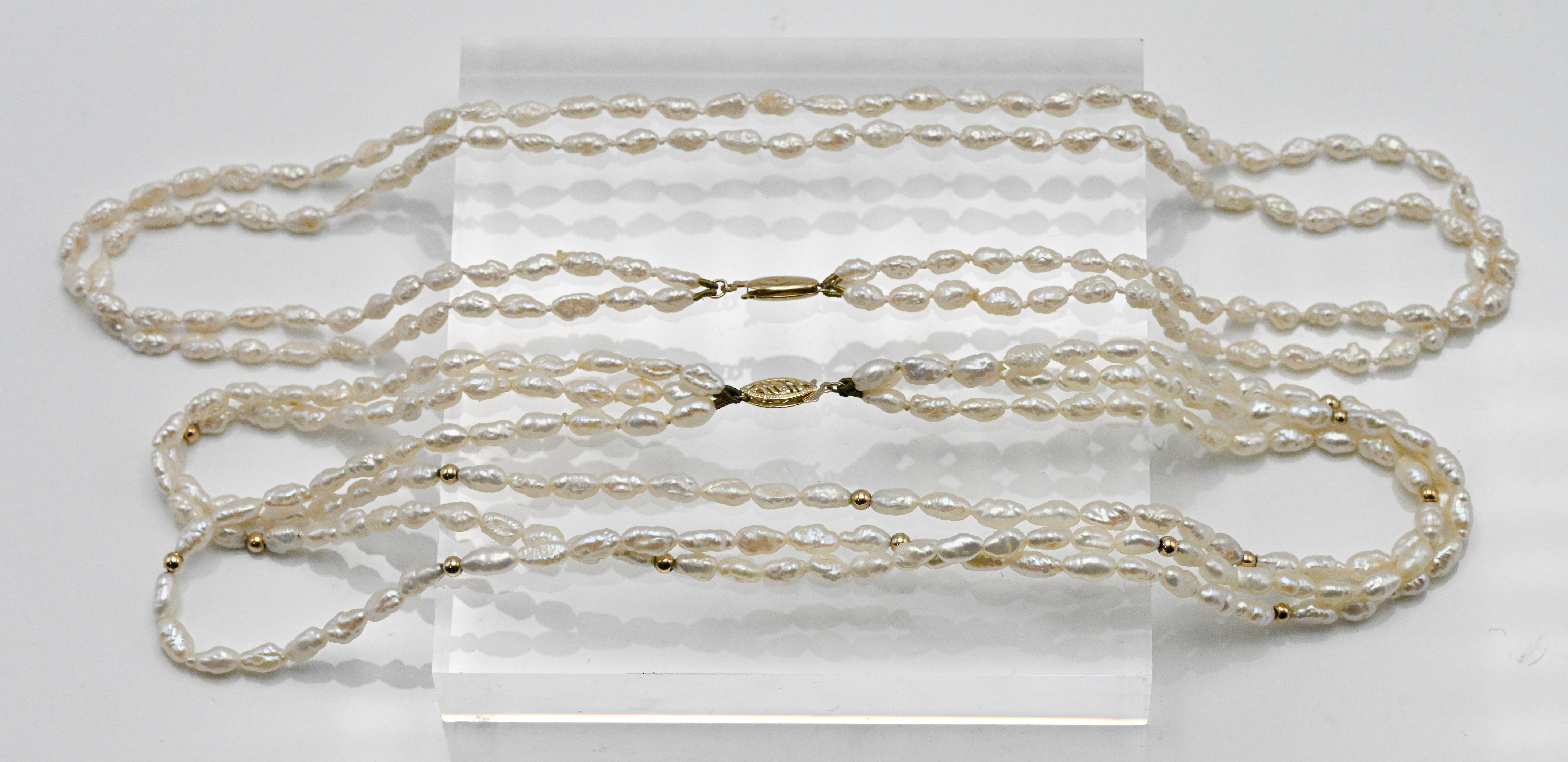 Two oriental seed pearl necklaces three row with gold bead insets, approx. length: 40cm, 14kt gold
