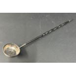 A silver punch ladle, with George IV 1724 coin in the base on whale bone handle.