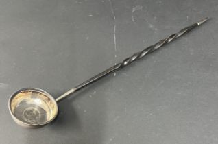 A silver punch ladle, with George IV 1724 coin in the base on whale bone handle.