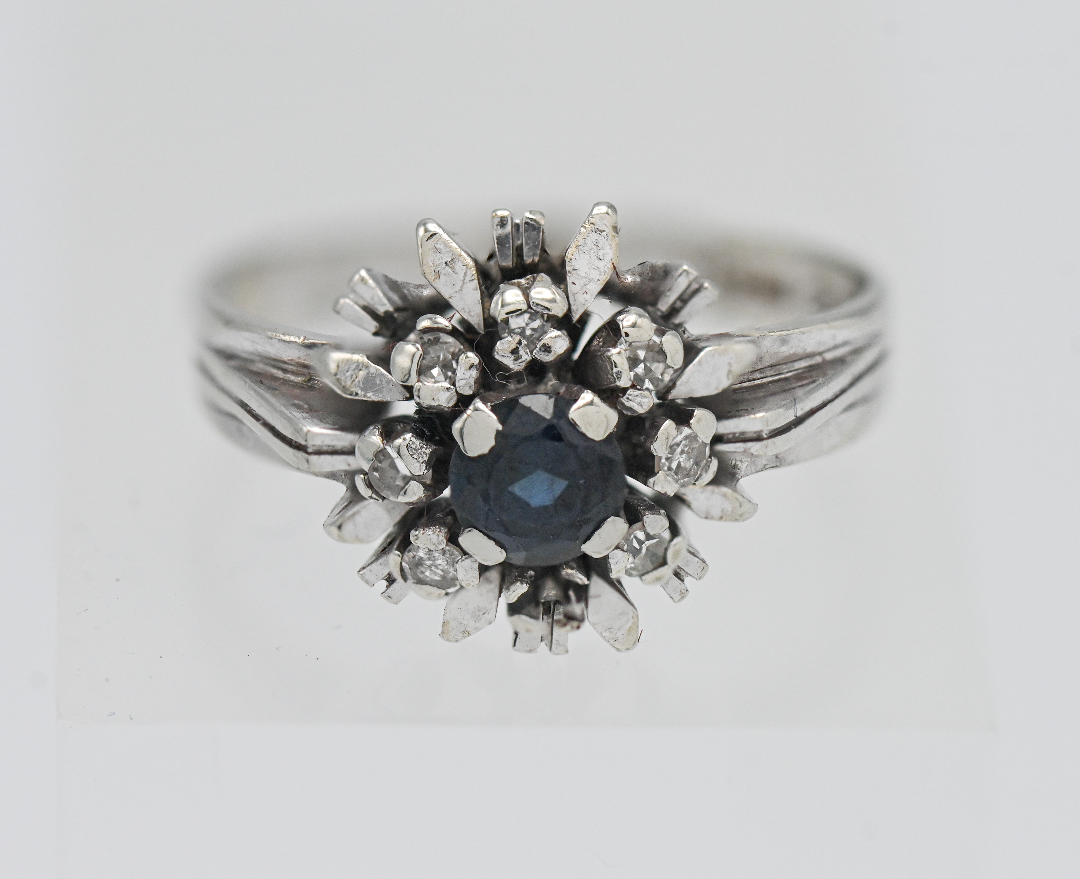 An 18 carat white gold sapphire and diamond cluster ring marked CV & Company approx. 4.5 grams