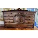 A miniature model of a sideboard with chequered inlay. With an arrangement of drawers and