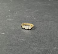 An 18ct yellow gold three stone diamond ring, size K.
