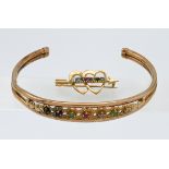 A 9 carat and coloured stone set 'slave' bangle together with a 9 carat double heart and stone set