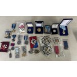 A mixed collection of military badges, reproduction medals, cloth badges, Royal Mint 1996 Silver