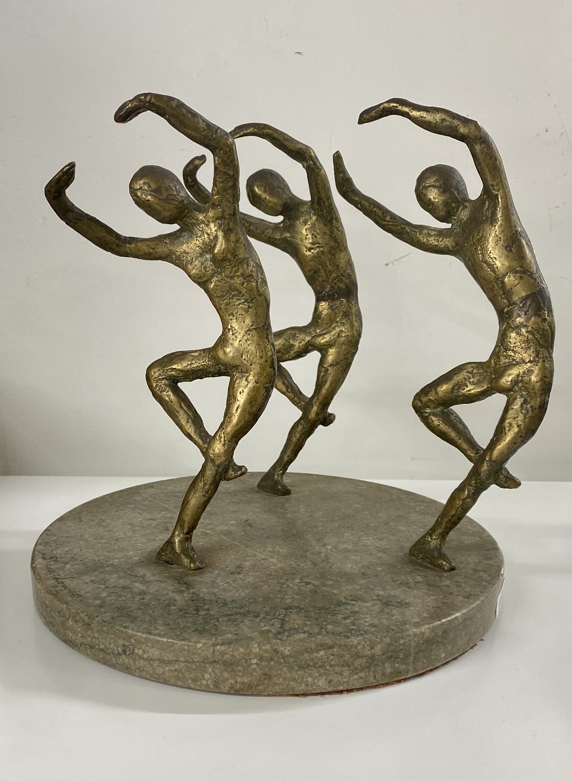 An interesting sculpture on marble base of three dancing figures, signed Lowdon? Diameter 22cm