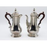A pair of modern silver coffee and hot water pots. Birmingham circa 1973, mark for JBC & S Ltd. 28cm