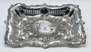 An Edwardian rectangular silver and pierced shallow dish, decorated with embossed flowers and