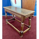 An antique joint oak stool. Length 92cm