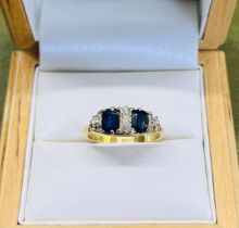 A sapphire and diamond ring, set in 18ct yellow gold, size K.