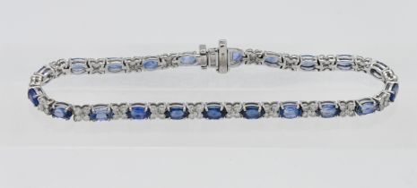 An 18ct white gold diamond and sapphire bracelet, length 18.5cm.