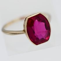An 18ct yellow gold and ruby style ring, 4.3g, size S/T.