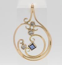 A gold diamond and sapphire pendant of contemporary design.