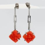 A pair of white gold and coral earrings.