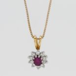 An 18ct yellow gold diamond and ruby pendant on a 9ct gold chain.