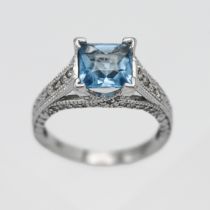 A 14ct white gold diamond and topaz ring, size N.