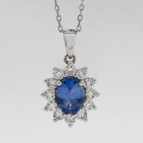 An 18ct white gold diamond and sapphire cluster pendant and chain.