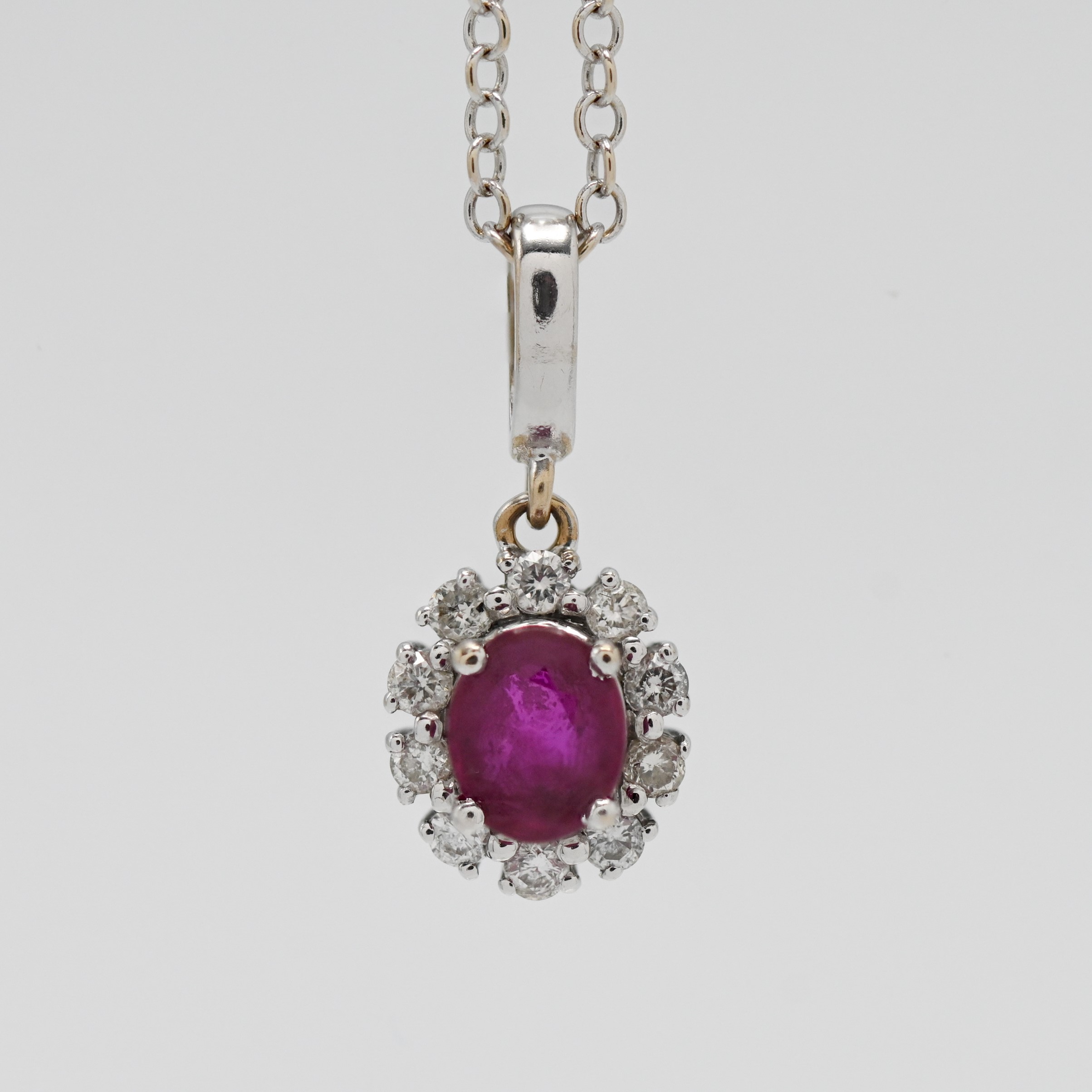 An 18ct white gold ruby and diamond pendant on chain.