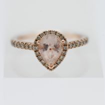 A 14kt rose gold, Le Vian ring set with a central pear cut stone surrounded by diamonds with further