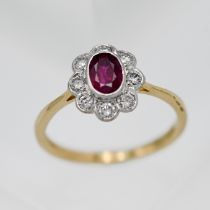An 18ct yellow gold ruby and diamond cluster ring, size L.