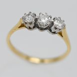 An 18ct three stone diamond ring, size N.