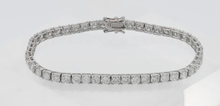A fine 18ct white gold diamond line bracelet, approx. 6.95ct, length 18.5cm.