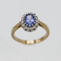 A 9k yellow gold tanzanite and diamond cluster ring, size K/L.