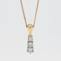 An 18ct gold three stone diamond pendant and chain.