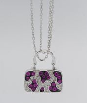 Iliana- an 18k white gold ruby and diamond pendant in the form of a bag, approx. 9.6g, with