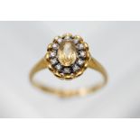 An 18ct yellow gold diamond and topaz cluster ring, total weight of diamond approx. 0.12ct, colour