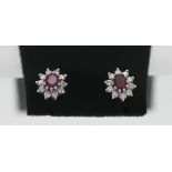 A pair of 18ct gold diamond and ruby studs.