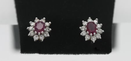 A pair of 18ct gold diamond and ruby studs.
