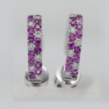 A pair of 18ct white gold diamond and pink sapphire hoop earrings.