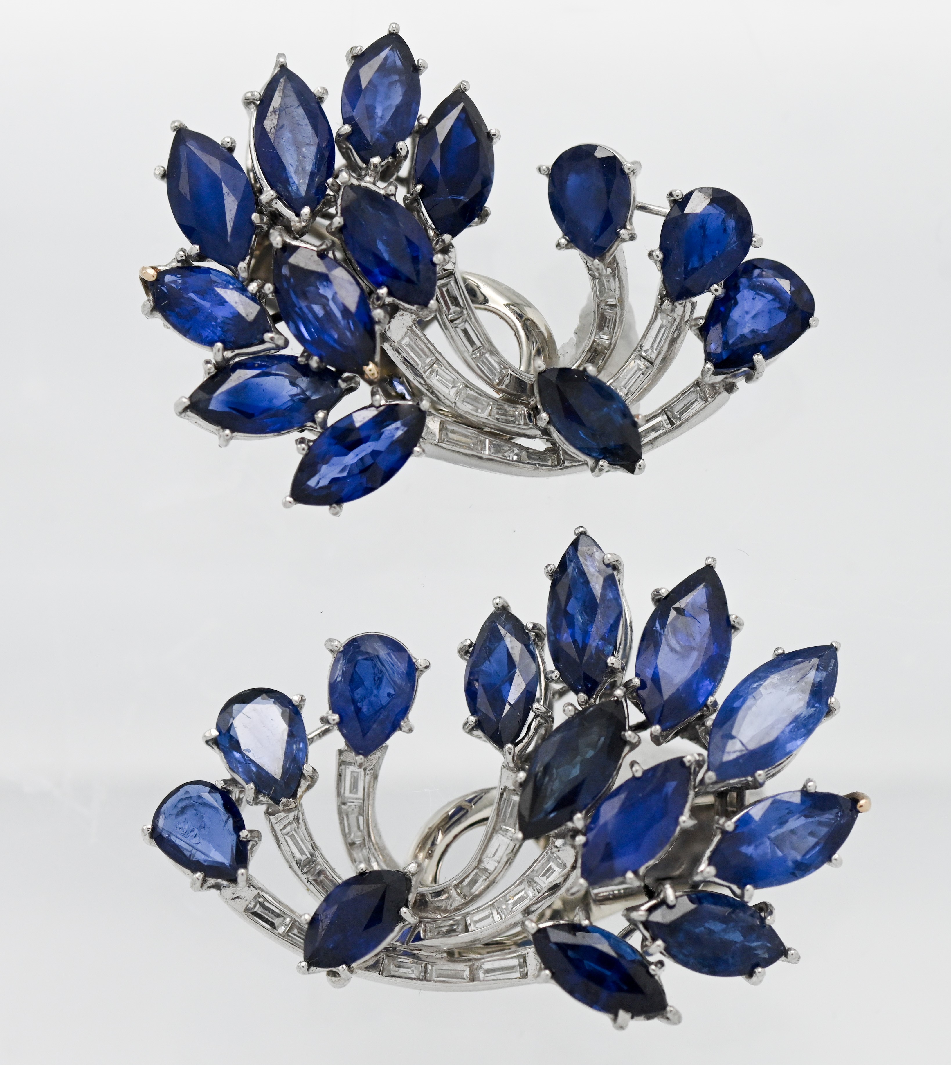 An impressive and valuable pair of diamond and sapphire clip on earrings (not hallmarked).