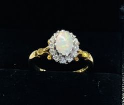 An 18ct opal and diamond cluster ring, size M
