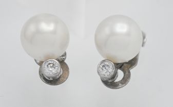 A pair of pearl and diamond clip on earrings (The Pearl Company).