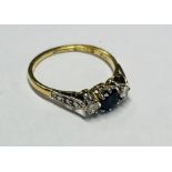 An 18ct yellow gold diamond and sapphire ring, size N/O.