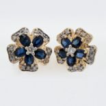A pair of 14ct diamond and sapphire 'flower' style studs.