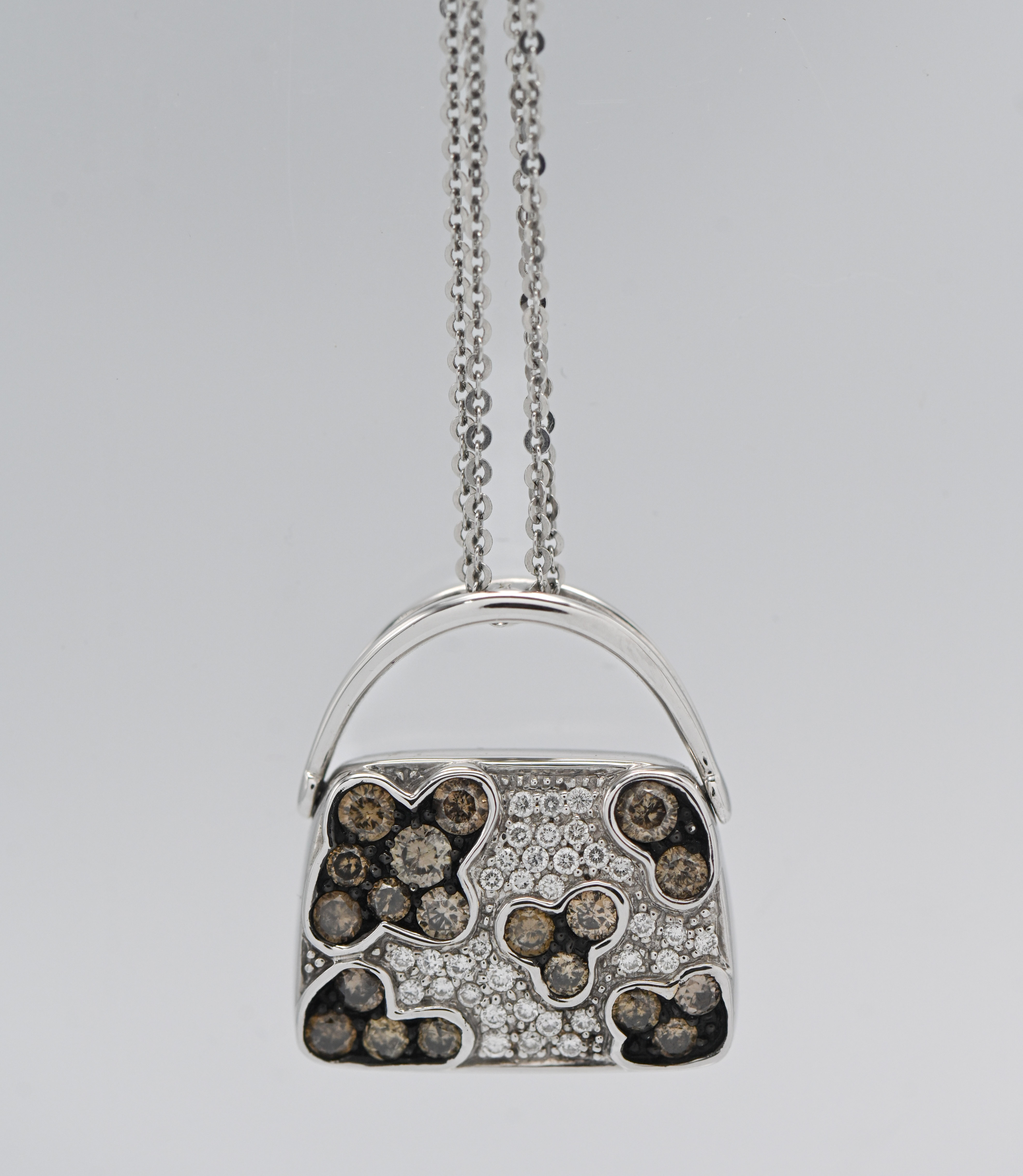 Iliana - an 18k white gold and diamond set pendant in a form of a bag, approx. 9.4g with receipt.